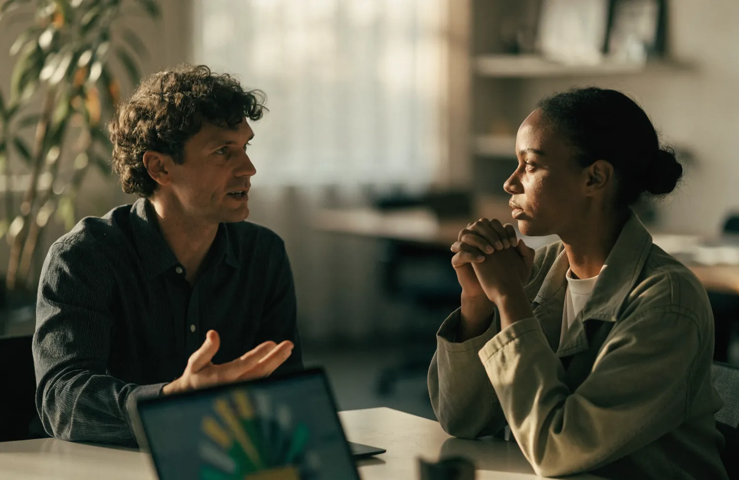 A commodity buyer and a commercial coordinator in conversation across a table